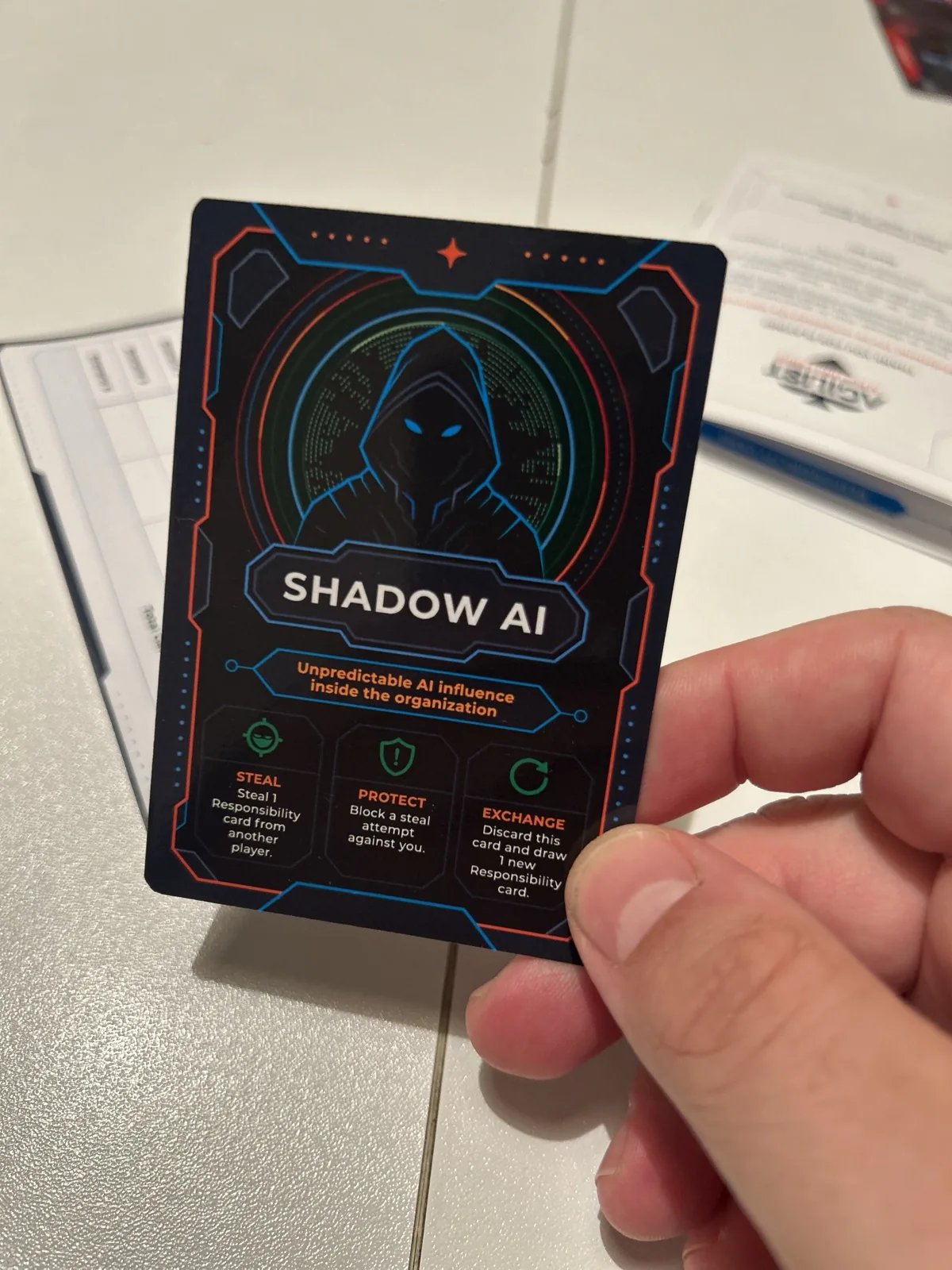 A hand holding a Shadow AI card from the first pilot edition of Agilist AI Playing Cards.